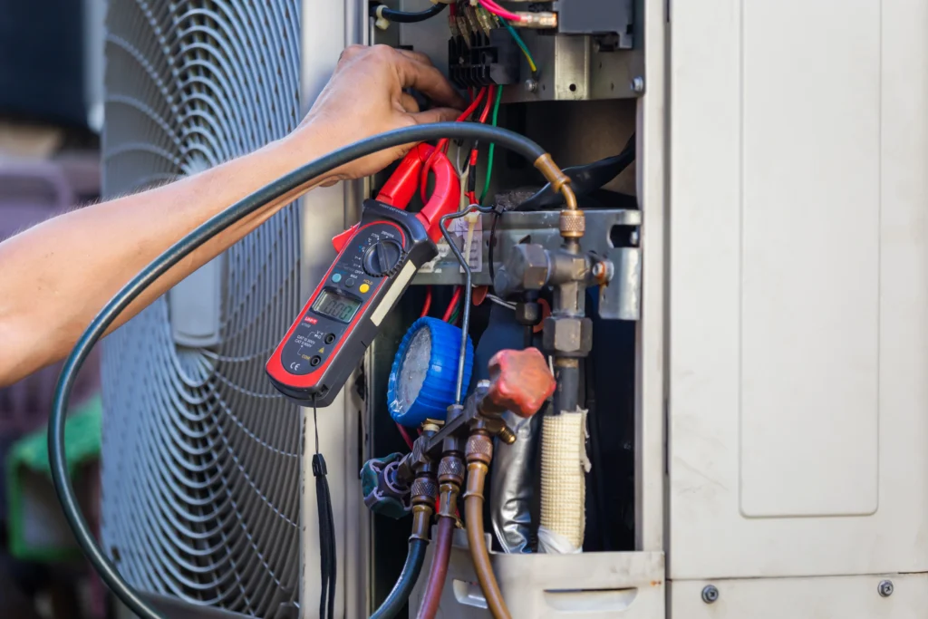 Cool Jay’s Air Conditioning expert diagnosing air conditioner issue in Bakersfield property
